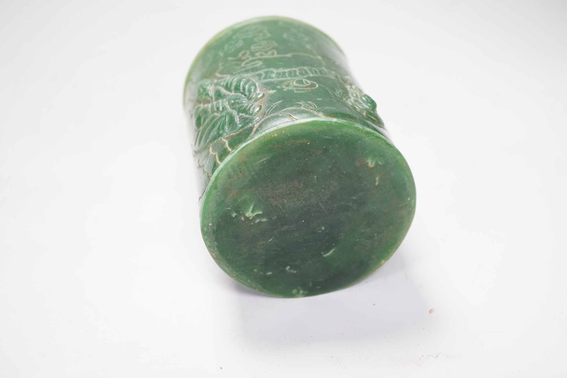 A Chinese incised green glass cylindrical brushpot, 11cm